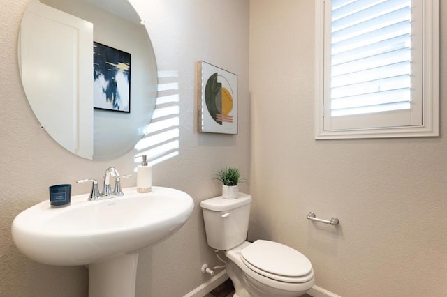 bathroom featuring toilet and sink