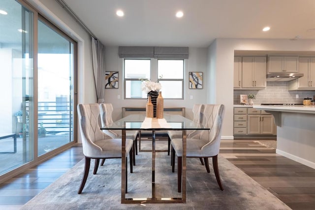 dining space with a healthy amount of sunlight and dark hardwood / wood-style flooring