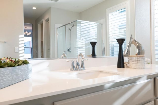 bathroom featuring vanity and a shower with shower door