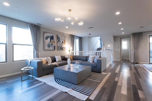 living room with wood-type flooring and a chandelier