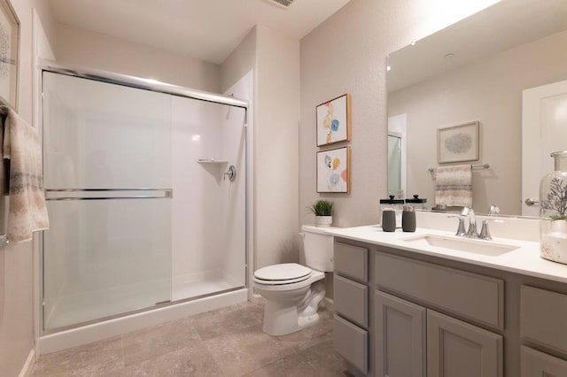 bathroom featuring vanity, toilet, and a shower with door