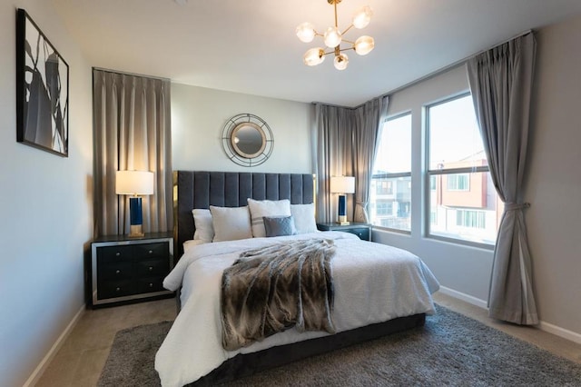 carpeted bedroom with multiple windows and a chandelier