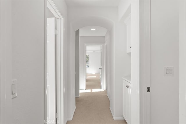 hallway featuring light colored carpet