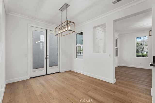 spare room with light wood-type flooring, french doors, and crown molding