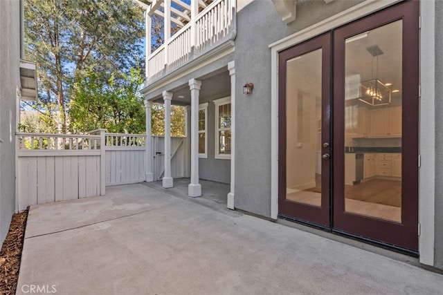 view of patio with a balcony and french doors