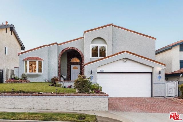 mediterranean / spanish home featuring a front yard