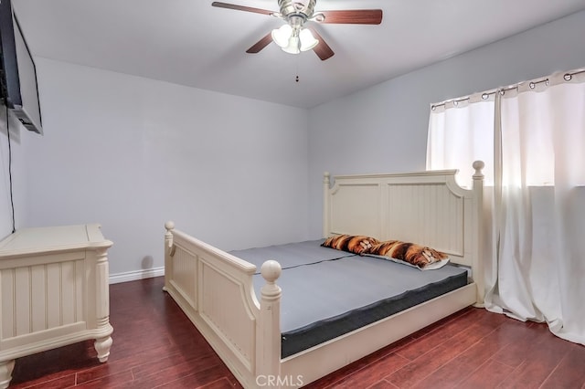 bedroom featuring ceiling fan and dark hardwood / wood-style flooring