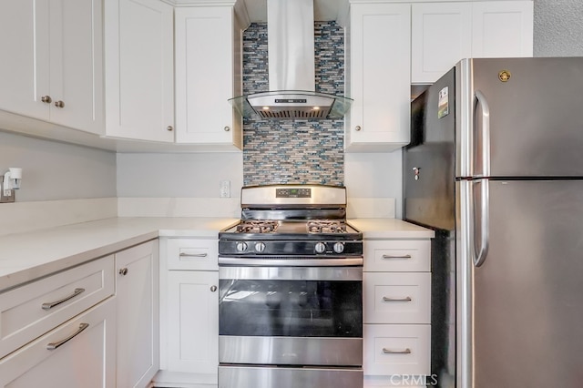 kitchen with wall chimney range hood, stainless steel appliances, white cabinetry, and backsplash