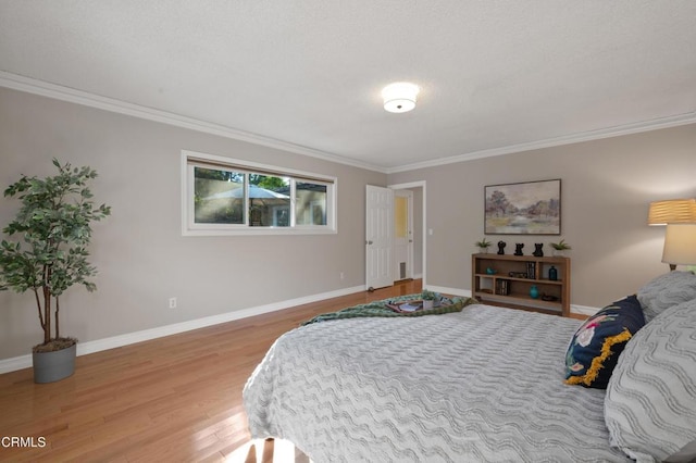 bedroom with light wood-type flooring and crown molding