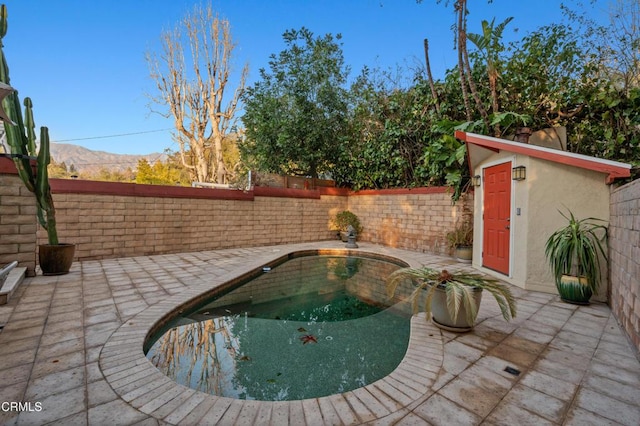 view of pool featuring a mountain view and a patio