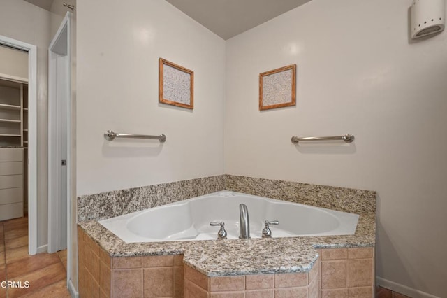 bathroom with tiled bath