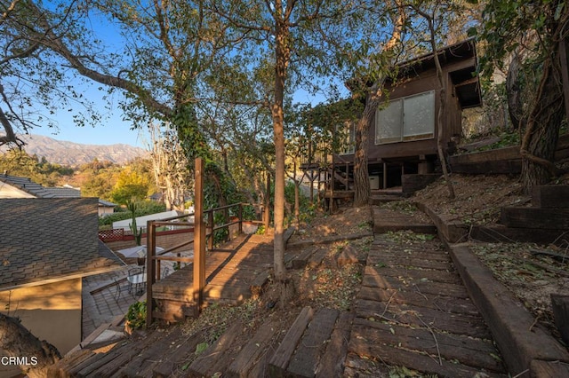 view of yard with a mountain view and a patio