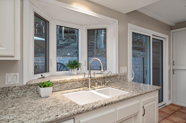 kitchen featuring sink, white cabinets, and light tile patterned floors