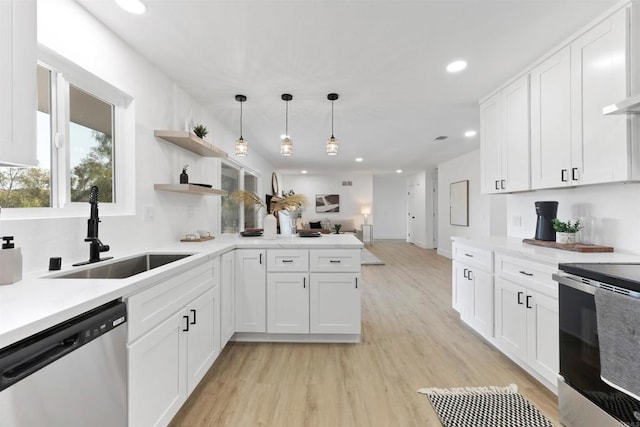 kitchen with stainless steel appliances, decorative light fixtures, sink, and white cabinets