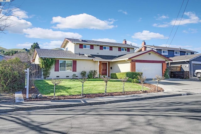 view of front of property featuring a garage and a front lawn