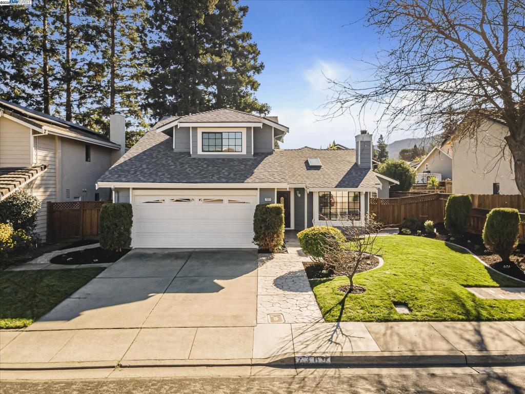 view of property with a garage and a front yard