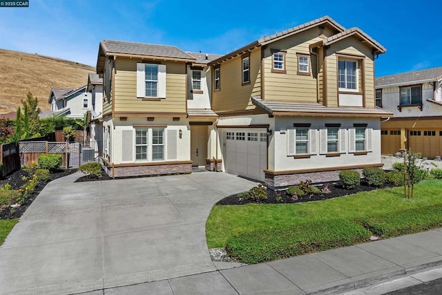 view of front of property with a garage and a front yard