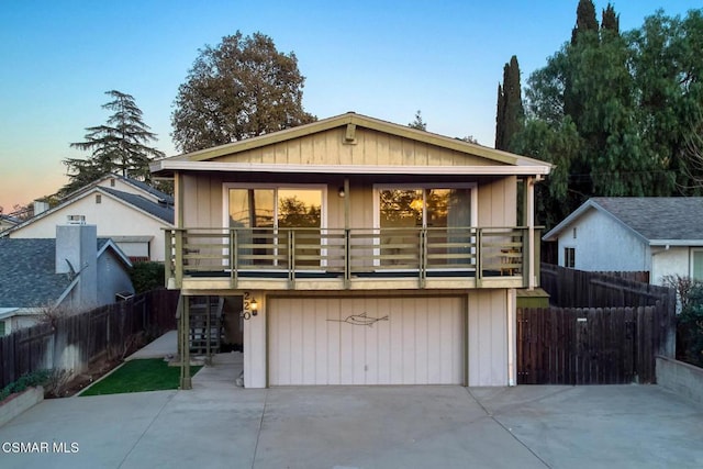 view of front of property with a balcony and a garage