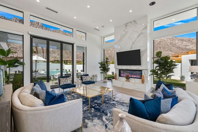 living room with a premium fireplace and hardwood / wood-style flooring