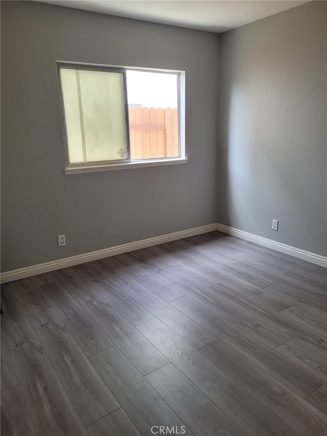 unfurnished room with dark hardwood / wood-style floors