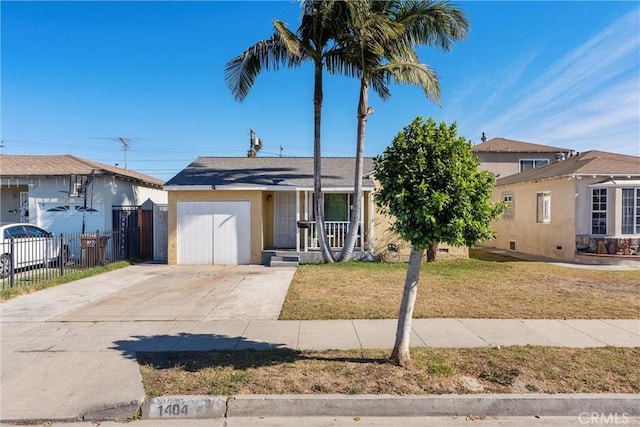 view of front of property with a front yard and a garage