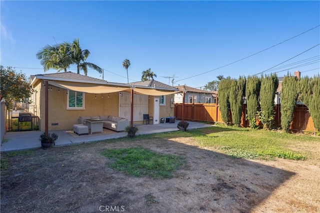 rear view of house featuring an outdoor hangout area, a yard, and a patio area