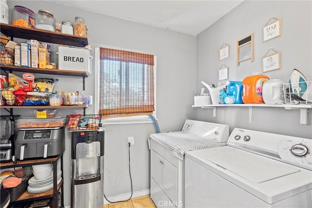 washroom with washing machine and dryer and light tile patterned floors