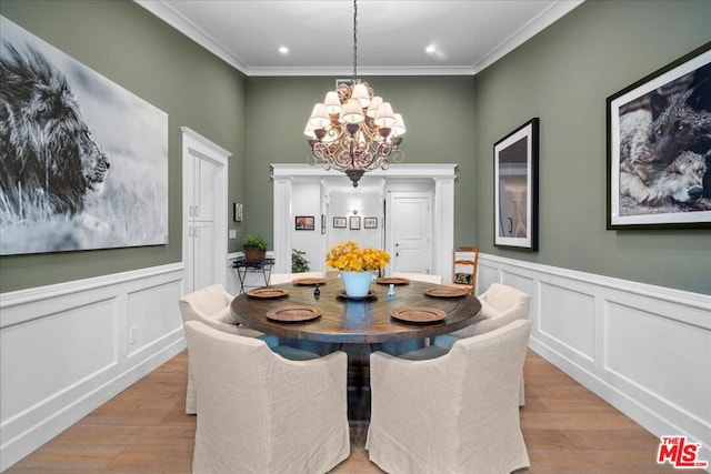 dining room featuring ornamental molding, a chandelier, and light wood-type flooring