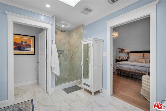 bathroom with a shower with shower door and crown molding