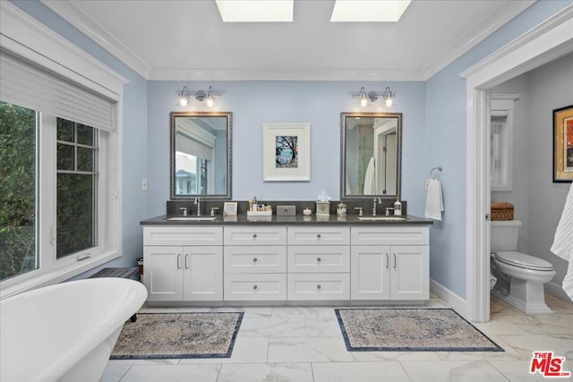 bathroom with crown molding, toilet, a bathing tub, and vanity