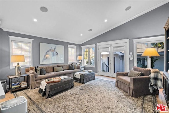 living room with vaulted ceiling, crown molding, and light hardwood / wood-style floors