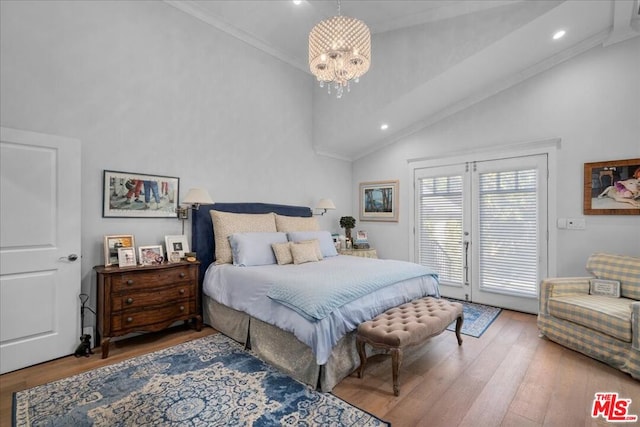 bedroom featuring hardwood / wood-style flooring, french doors, ornamental molding, an inviting chandelier, and lofted ceiling