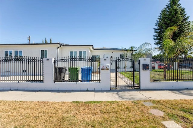 view of gate featuring a yard