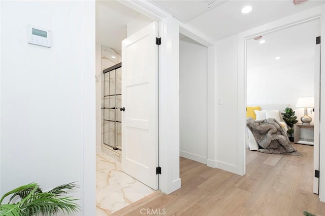 corridor with light hardwood / wood-style flooring