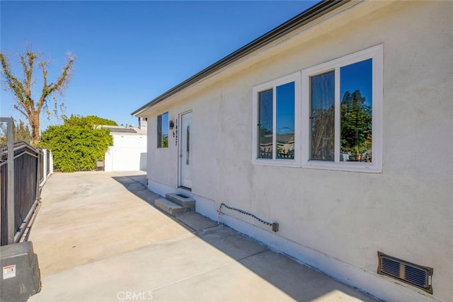 view of side of property with a patio area