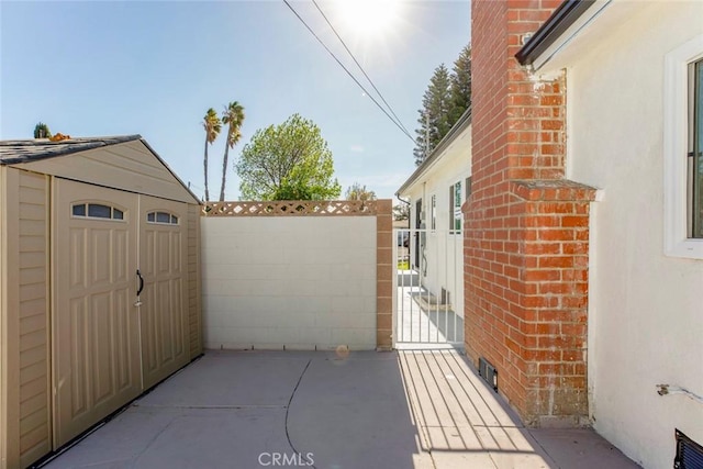 view of patio with a storage shed