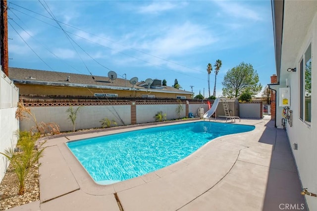 view of pool with a patio and a water slide