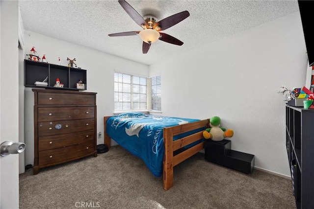 carpeted bedroom featuring ceiling fan and a textured ceiling