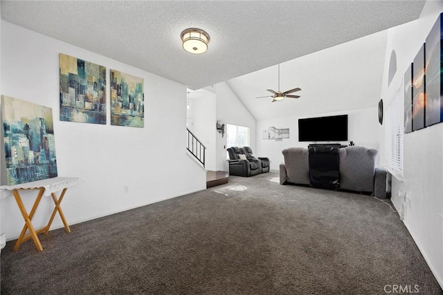 unfurnished living room with dark colored carpet, a textured ceiling, ceiling fan, and vaulted ceiling