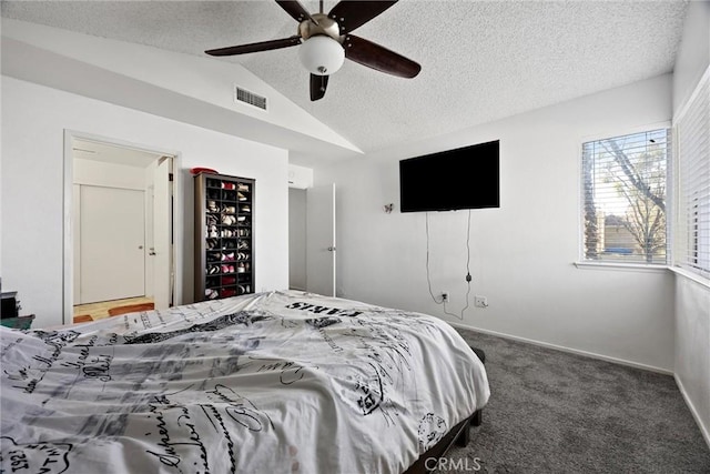 carpeted bedroom featuring lofted ceiling, a textured ceiling, and ceiling fan