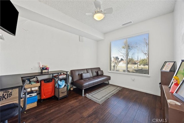 sitting room featuring ceiling fan, a textured ceiling, and dark hardwood / wood-style floors