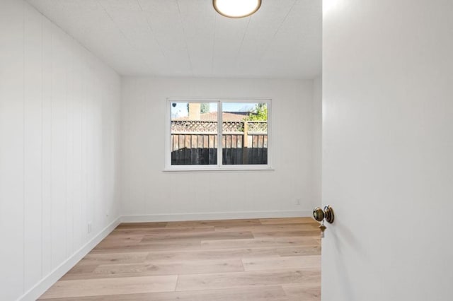 empty room with light hardwood / wood-style flooring