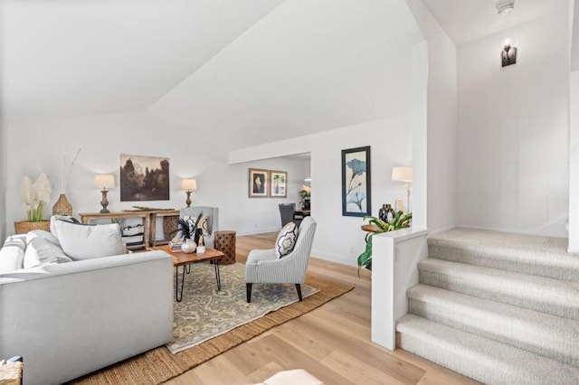 living room featuring hardwood / wood-style flooring and lofted ceiling