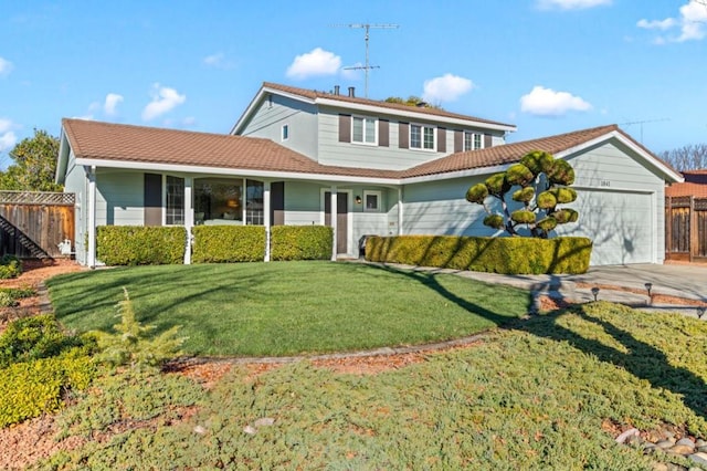 view of front property featuring a garage and a front yard