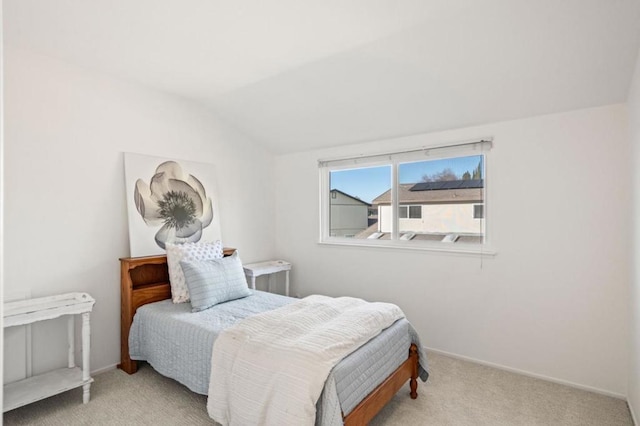 carpeted bedroom with lofted ceiling