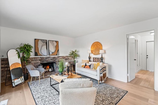 living room with a fireplace and light hardwood / wood-style flooring