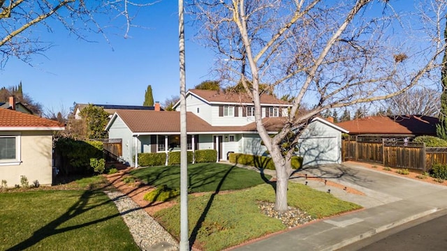 front of property featuring a garage, a front lawn, and an outdoor structure