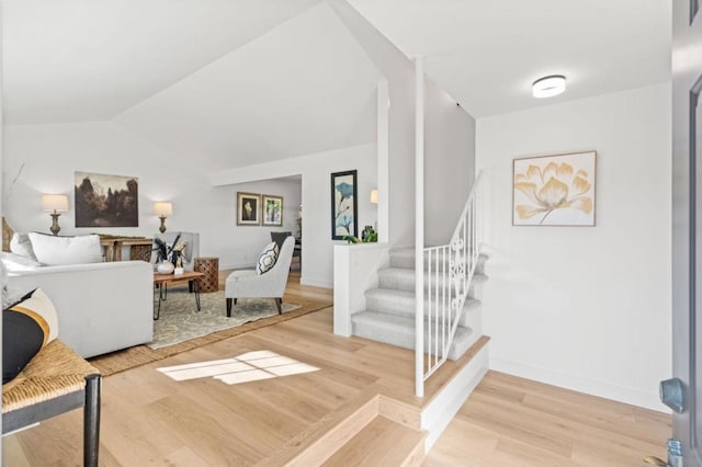 living room with hardwood / wood-style floors and lofted ceiling