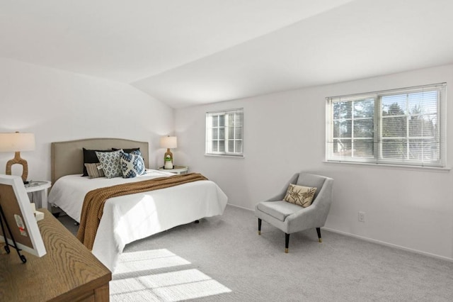 bedroom featuring light colored carpet, multiple windows, and lofted ceiling