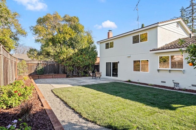 back of house with a patio and a lawn